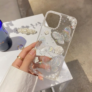 Detailed view of transparent phone case with iridescent butterflies and pearl edges