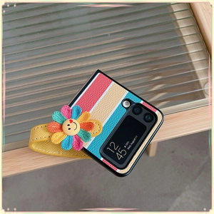 Detail of multi-color striped folding phone case with 3D flower wrist strap and leather grip