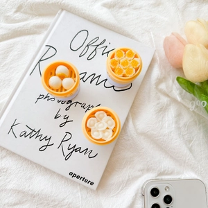 Three realistic dim sum phone grips including dumpling and baozi on a white background