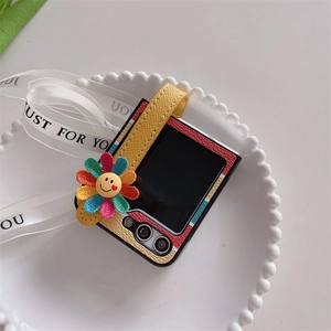 Detail of color-block leather phone case for Galaxy Z Flip with striped strap and flower charm