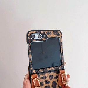 Detail of leopard print foldable phone case with brown leather crossbody shoulder strap