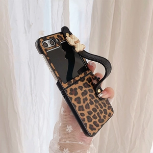 Detail of leopard print foldable phone case with leather wrist strap and bow ornament