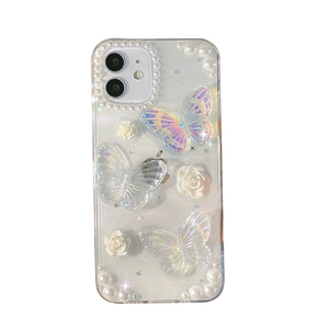 Clear iPhone case featuring 3D holographic butterflies, white roses and pearl accents