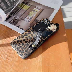 Detail of leopard print folding phone case with leather strap and white 3D flowers
