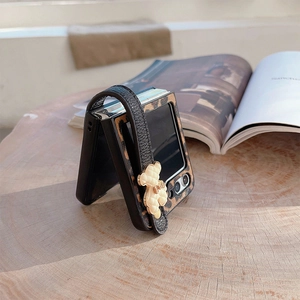 Leopard print Samsung Z Flip case with a leather wrist strap and teddy bear charm