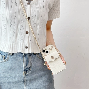 White quilted iPhone case detail with gold chain strap and metal rose pocket clasp