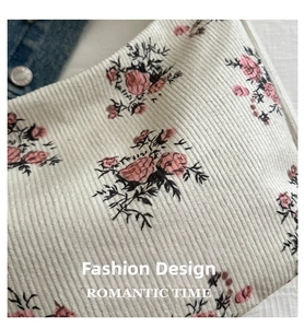 Close-up of white corduroy fabric with vintage pink rose floral pattern texture