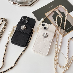 Detail of luxury camellia pearl crossbody phone case with quilted leather and long chain