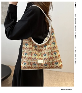 Detail of geometric pattern woven shoulder bag featuring a stylish fashion label