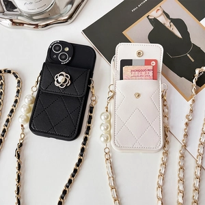 Detail of quilted leather phone case with camellia pearl decor and crossbody strap