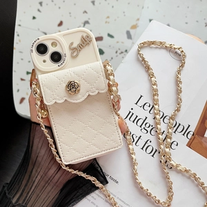 Detail of cream iPhone case with quilted leather wallet, gold flower and crossbody chain