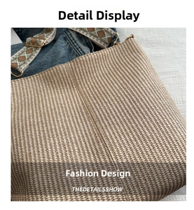 Detail of woven tote bag featuring a bohemian jacquard strap and metal adjustment buckle