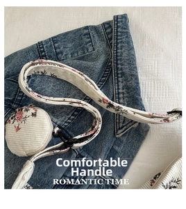 Floral corduroy strap with a round mini coin purse and black metal hardware detail