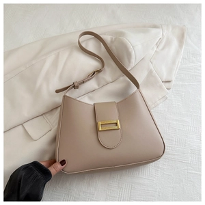 Detail of khaki PU leather bag with elegant golden rectangular metal clasp and adjustable strap