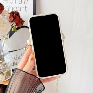 Detail of white leather cross-body chain with gold bell pendant for iPhone case