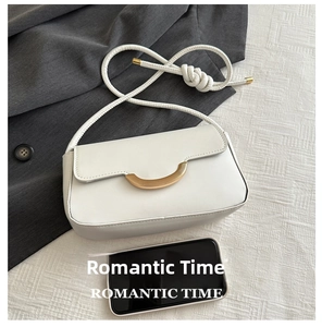 Minimalist white crossbody bag detail showing size comparison with a smartphone