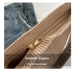 Close-up of smooth metal zipper and premium woven texture on retro light brown tote bag