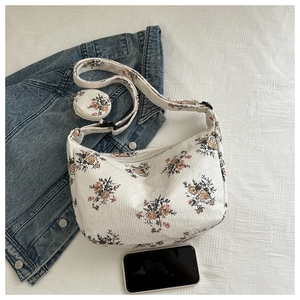 Detail view of floral corduroy hobo bag with a matching small round coin purse accessory