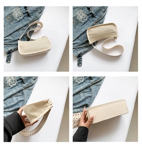 Detail showing woven texture and PU leather trim of the stylish straw underarm bag