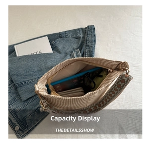 Detail showing spacious interior of beige woven tote bag with ethnic embroidered strap