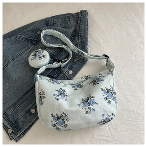 Detail of floral nylon shoulder bag with a matching small round coin purse accessory