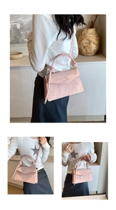 Pink glossy patent leather crossbody bag with pleated texture and round handle detail