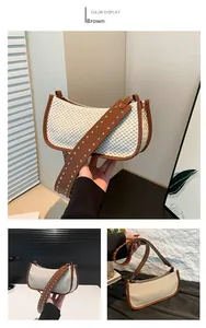 Detail of straw patchwork bag with brown leather trim and silver studded wide shoulder strap