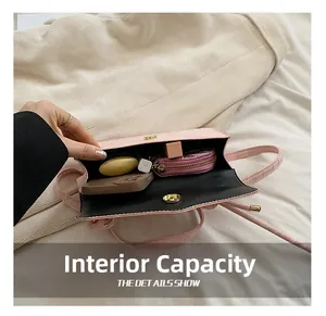 Internal view of pink crocodile pattern crossbody bag showing capacity for phone and cosmetics