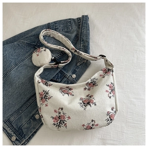 Macro detail of floral corduroy shoulder bag with matching round small coin purse