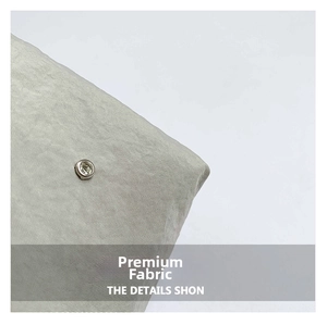 Macro view of light grey textured nylon fabric with a silver rhinestone stud detail