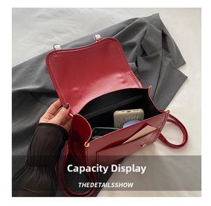 Detailed interior of a vintage red leather flap bag showing storage for phone and wallet