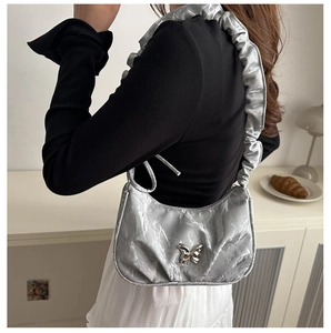 Detail of silver marble pleated underarm bag with butterfly buckle and ruffled strap