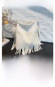 Detail of white lychee grain tote bag with metal rivets and long fringe tassels