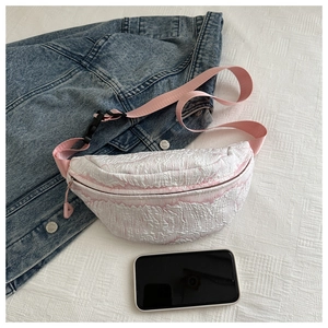 Detailed macro view of pink and white bubble texture fabric on a large capacity crossbody bag