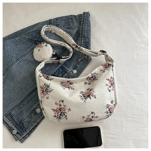 Detail of floral corduroy hobo bag with matching mini round pouch and adjustable strap