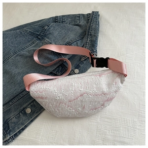 Detail of pink bubble texture fabric on a stylish waist bag with pink nylon strap