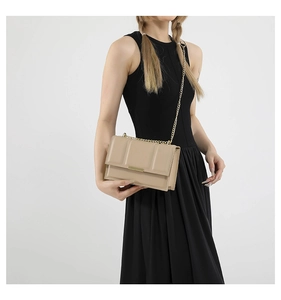 Close-up of beige chain bag with vertical textures and gold rectangle buckle detail
