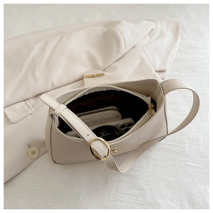 Internal view of beige shoulder bag showing large capacity for phone and wallet