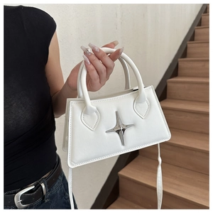 Détail du sac à main trapèze blanc mat avec ornement métallique étoile argentée polie