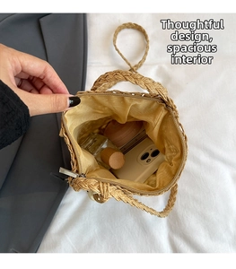 Interior view of straw bucket bag showing storage space for phone and makeup accessories