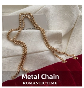 Close-up of burgundy velvet chain bag showing quilted texture and gold hardware