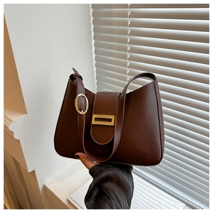 Detail of dark brown hobo bag showing golden hardware and textured synthetic leather