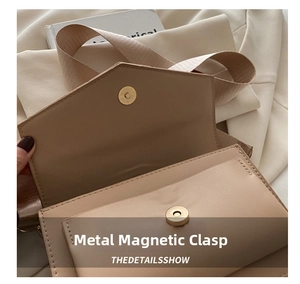 Detailed close-up of a premium leather handbag showing a secure magnetic snap button closure