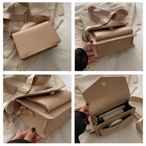 Detail view of apricot crossbody bag with adjustable wide strap and multi-layer interior