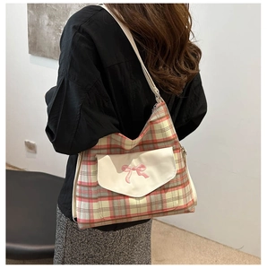 Detail of vintage plaid tote bag with pink bow embroidery and canvas front pocket