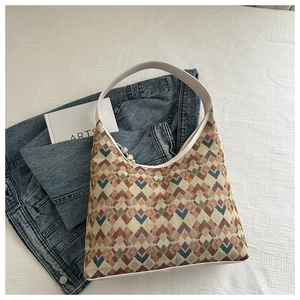 Detail of geometric woven patterns in earthy tones on a stylish nylon tote bag