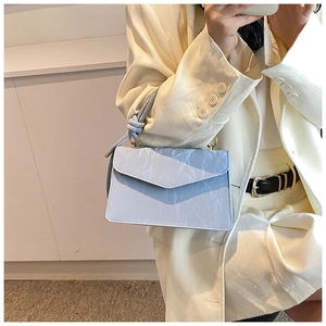 Light blue pleated leather handbag detail with metal ring handle and shoulder strap