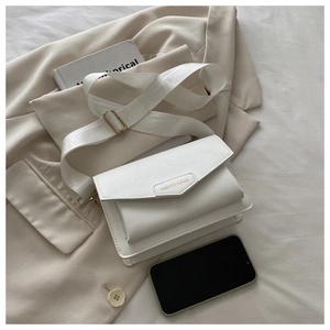 Detail of white envelope crossbody bag with wide strap and embossed fashion label
