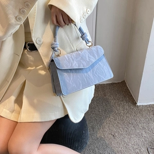 Elegant light blue textured crossbody bag with knotted handle for women's summer fashion