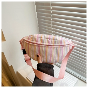 Détail d'un sac banane à rayures colorées montrant la texture seersucker et le zip rose